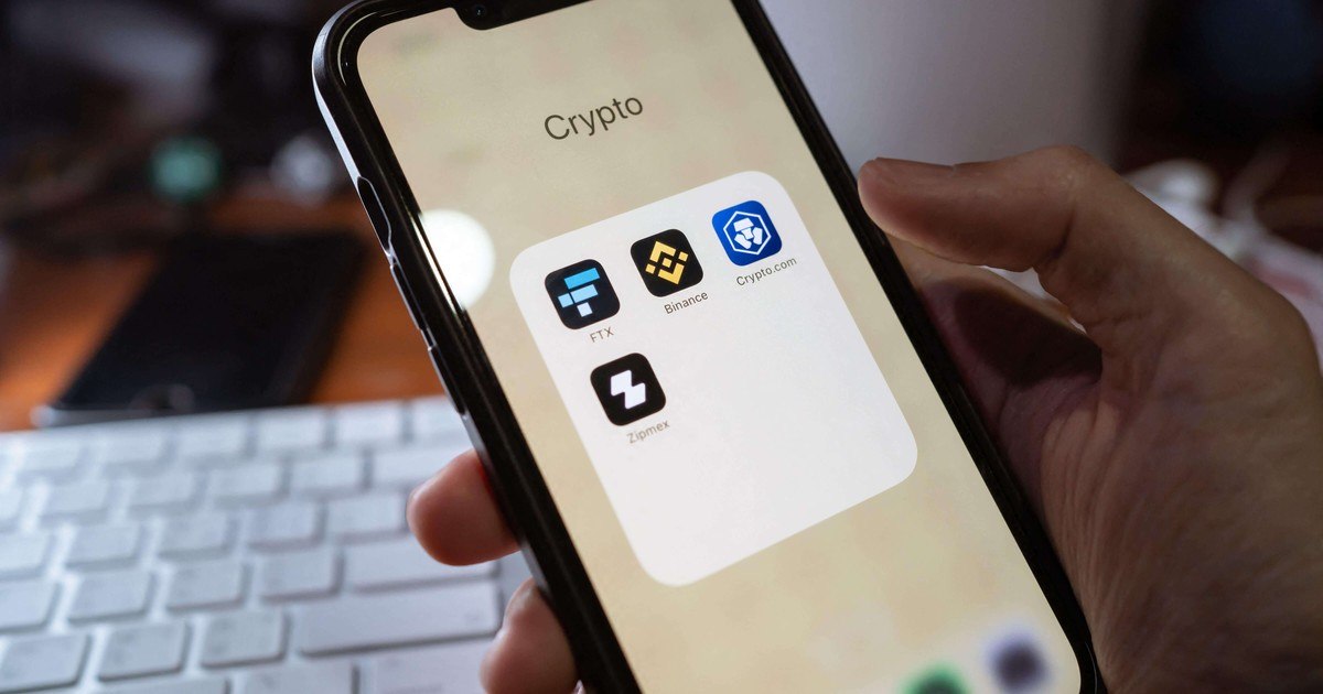 Is Crypto Trading Gambling? A UNLV Researcher Weighs In Person tracking cryptocurrency prices on a smartphone late at night